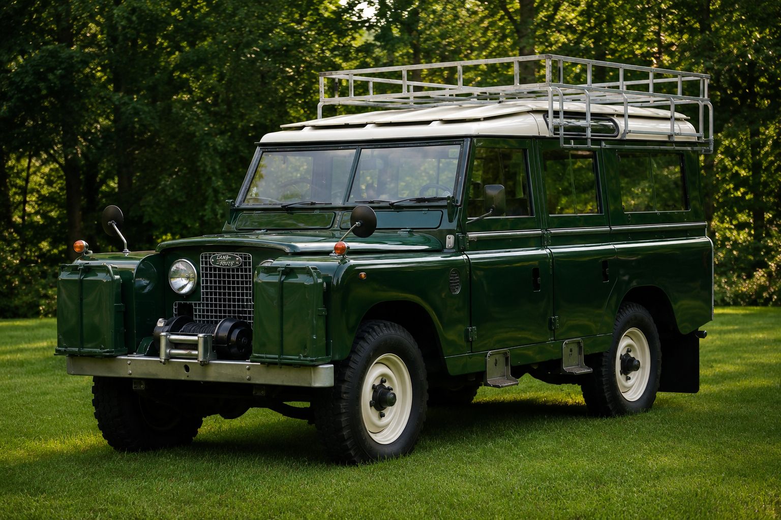 Vintage green Land Rover Series vehicle parked on grass